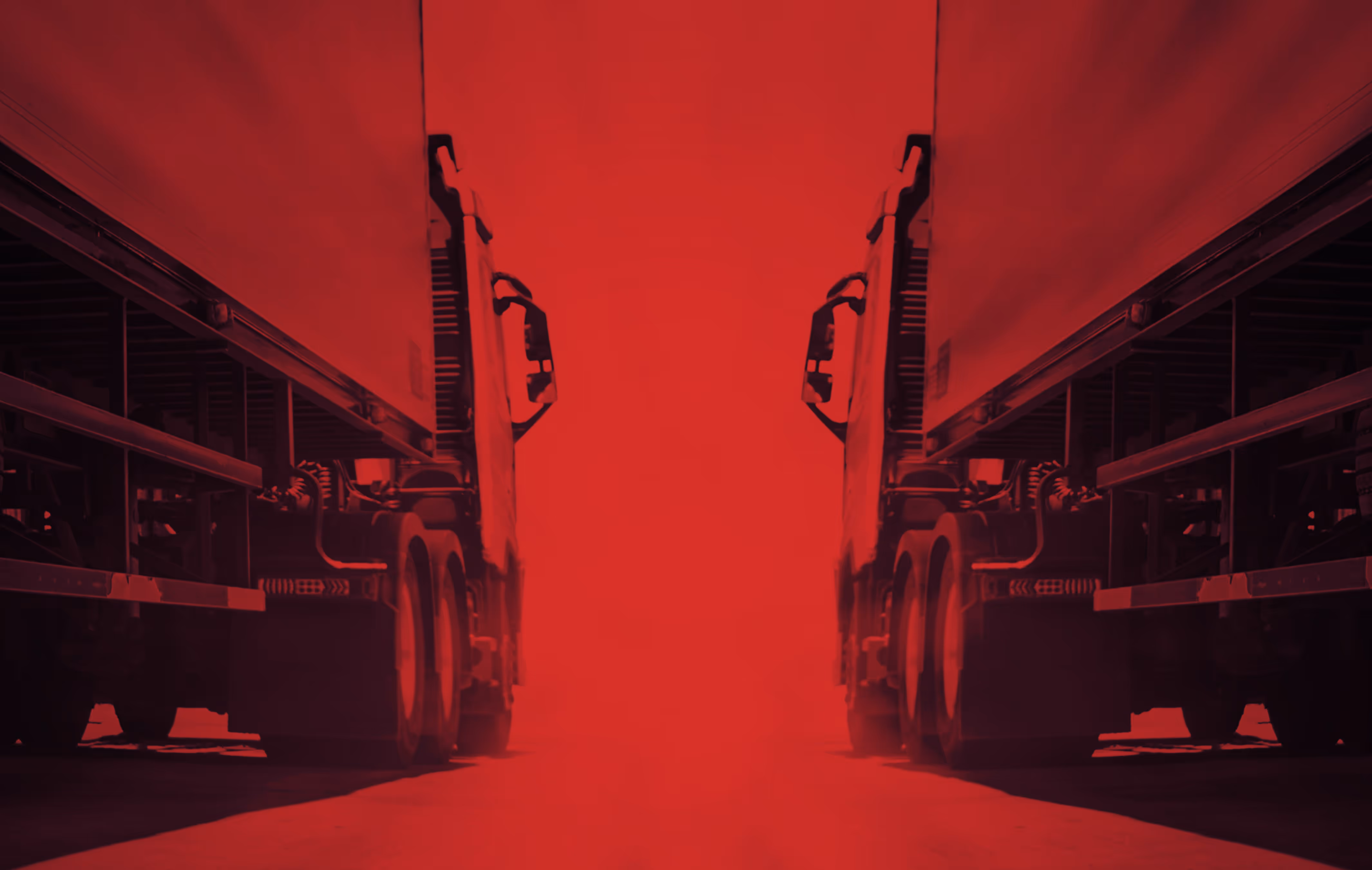 Two semi trucks facing each other with a red overlay emphasizing the space between them.